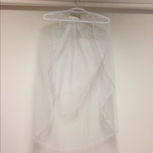 Fingertip length veil with beaded edge